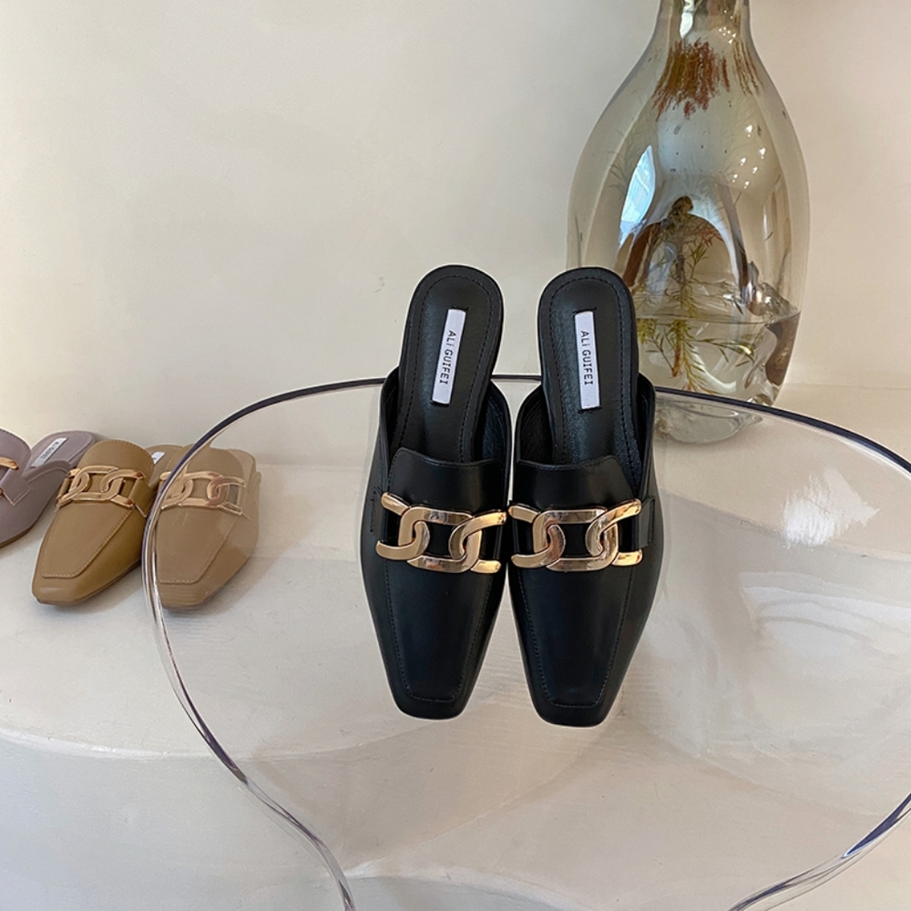 Black mules with gold buckle